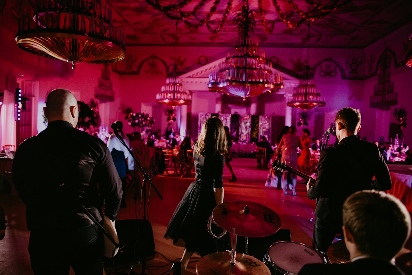 Band performs for guests in an ornate ballroom.